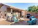 Inviting backyard featuring patio furniture, a grill, and a well-maintained brick patio under a cozy overhang at 42568 W Bunker Dr, Maricopa, AZ 85138
