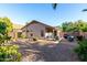 Serene backyard with stone landscaping, patio furniture, and a grill, perfect for outdoor relaxation at 42568 W Bunker Dr, Maricopa, AZ 85138