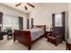 This bedroom features vaulted ceilings, a ceiling fan, a desk area, and a sleek, neutral color palette at 42568 W Bunker Dr, Maricopa, AZ 85138