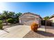 Single-story home with desert landscaping, a concrete driveway, and a neutral exterior paint scheme at 42568 W Bunker Dr, Maricopa, AZ 85138