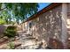 Side view of the home, showcasing landscaping, a neutral exterior, and a pathway at 42568 W Bunker Dr, Maricopa, AZ 85138