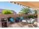 Inviting patio area with comfortable seating and a fire pit, perfect for outdoor entertaining and relaxation at 42568 W Bunker Dr, Maricopa, AZ 85138