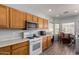 Kitchen area featuring gas range, wood cabinets, and breakfast nook at 45105 W Gavilan Dr, Maricopa, AZ 85139