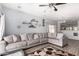 Open living area features wood flooring, ceiling fan, and view into kitchen at 45105 W Gavilan Dr, Maricopa, AZ 85139