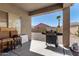 Covered patio featuring a grill, chairs and a view of the backyard at 45105 W Gavilan Dr, Maricopa, AZ 85139