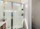 Glass enclosed shower with a window and light walls at 45105 W Gavilan Dr, Maricopa, AZ 85139