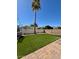 A well manicured backyard with artifical turf grass and a brick laid patio at 4779 W Tulsa St, Chandler, AZ 85226