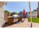 Outdoor kitchen with stone accents, a built-in gas grill, and well-kept patio for great backyard entertaining at 4779 W Tulsa St, Chandler, AZ 85226
