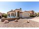Charming single-story home featuring desert landscaping, a two-car garage, and a cozy seating area at the front of the property at 4779 W Tulsa St, Chandler, AZ 85226