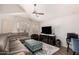 Bright living room features vaulted ceilings, plantation shutters, a ceiling fan, and a comfortable gray sectional sofa at 4779 W Tulsa St, Chandler, AZ 85226