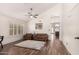 Inviting living room with high ceilings, plantation shutters, and wood-look floors, creating a warm and welcoming atmosphere at 4779 W Tulsa St, Chandler, AZ 85226