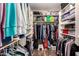 Organized walk-in closet with ample shelving, hanging space, and laminate flooring for efficient storage at 4779 W Tulsa St, Chandler, AZ 85226