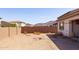 Spacious backyard featuring desert landscaping and a block fence offering privacy and views at 5226 W Thresher Way, Laveen, AZ 85339