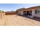 Spacious backyard featuring desert landscaping, block fence, and covered patio with mountain views at 5226 W Thresher Way, Laveen, AZ 85339