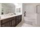 Bright bathroom features dual sinks, a soaking tub, and a large mirror at 5226 W Thresher Way, Laveen, AZ 85339