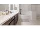 Bright bathroom featuring double sinks, a soaking tub, shower, and sleek countertops at 5226 W Thresher Way, Laveen, AZ 85339