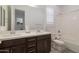 Bright bathroom with dual sinks, soaking tub, and dark wood cabinets at 5226 W Thresher Way, Laveen, AZ 85339
