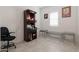 Clean and simple bedroom with tile flooring and a dark wood shrine and glass tables at 5226 W Thresher Way, Laveen, AZ 85339