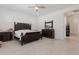 A spacious main bedroom features a ceiling fan, tile flooring, and dark wood furniture at 5226 W Thresher Way, Laveen, AZ 85339