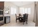 Cozy dining area with a modern light fixture, stainless steel appliances, and window shutters at 5226 W Thresher Way, Laveen, AZ 85339