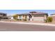 Street view of a one-story home featuring a two-car garage and desert landscaping at 5226 W Thresher Way, Laveen, AZ 85339