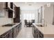 Open kitchen featuring stainless steel appliances, a large island, and dining area at 5226 W Thresher Way, Laveen, AZ 85339