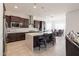 Bright, open kitchen with stainless steel appliances, a large island, and access to the dining area at 5226 W Thresher Way, Laveen, AZ 85339