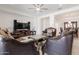 Elegant living room with designer furniture, high ceilings, ceiling fan, and open to the dining room at 5226 W Thresher Way, Laveen, AZ 85339