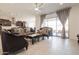 Bright living room featuring elegant sofas, tile flooring, and a sliding glass door for natural light at 5226 W Thresher Way, Laveen, AZ 85339