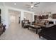 Spacious living room with tile floors, ornate sofas, and seamless transition to kitchen at 5226 W Thresher Way, Laveen, AZ 85339