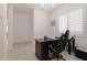Bright office space with a dark wood desk and a modern chandelier at 5226 W Thresher Way, Laveen, AZ 85339