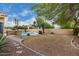 View of spacious backyard with desert landscaping, outdoor grill and fire pit at 53 W Pecan Pl, Tempe, AZ 85284