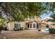 View of spacious backyard with covered patio, pool, built in BBQ and desert landscaping at 53 W Pecan Pl, Tempe, AZ 85284