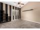Carpeted bedroom with a ceiling fan, modern shelving, and a large window with natural light at 53 W Pecan Pl, Tempe, AZ 85284