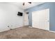 Cozy bedroom with a ceiling fan, a closet, and a TV mounted on the wall at 53 W Pecan Pl, Tempe, AZ 85284