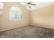 Bedroom featuring a ceiling fan and a large window with a decorative arched top at 53 W Pecan Pl, Tempe, AZ 85284