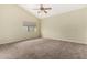 Neutral bedroom featuring neutral walls, carpet, a ceiling fan, and a window providing natural light at 53 W Pecan Pl, Tempe, AZ 85284