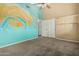 Bedroom featuring a mural, a ceiling fan, and a double-door closet for ample storage at 53 W Pecan Pl, Tempe, AZ 85284