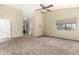 Spacious primary bedroom featuring neutral walls, carpet, and access to an en-suite bathroom at 53 W Pecan Pl, Tempe, AZ 85284