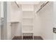 Interior of a walk-in closet with carpet flooring and built-in shelves and hanging rods at 53 W Pecan Pl, Tempe, AZ 85284
