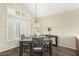Inviting dining room with vaulted ceiling, a decorative chandelier, and shuttered windows at 53 W Pecan Pl, Tempe, AZ 85284