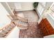 View of the home's foyer shows tile flooring, wood staircase, a large window, and a chandelier at 53 W Pecan Pl, Tempe, AZ 85284