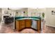 Kitchen island that overlooks the living area with bar stool seating and stainless appliances at 53 W Pecan Pl, Tempe, AZ 85284