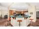 Bright, inviting kitchen with wood cabinets, stainless steel appliances, green countertops and a breakfast bar with orange stools at 53 W Pecan Pl, Tempe, AZ 85284
