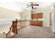 Open second-floor landing with wood railing, neutral carpet, built-in cabinets, and a decorative window at 53 W Pecan Pl, Tempe, AZ 85284