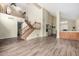 Spacious living room with hardwood floors, a staircase, and a wet bar with wood cabinets at 53 W Pecan Pl, Tempe, AZ 85284