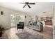 Open-concept living room with access to the patio, ceiling fan, and view into the kitchen at 53 W Pecan Pl, Tempe, AZ 85284