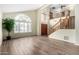 Spacious living room featuring wood-look floors, stairs, an arched window, and a large entryway at 53 W Pecan Pl, Tempe, AZ 85284