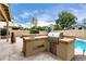 Outdoor kitchen area featuring a built-in grill and sink, perfect for backyard gatherings near the pool at 53 W Pecan Pl, Tempe, AZ 85284