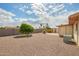 Private backyard with desert landscaping, a small tree, and block wall fencing at 5323 E Dodge St, Mesa, AZ 85205